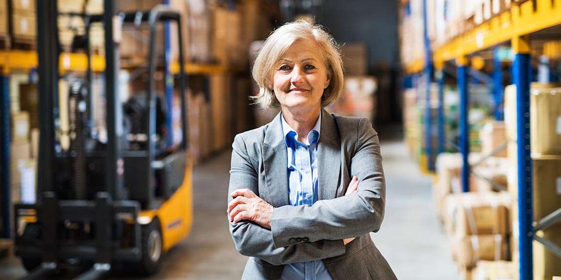 senior woman warehouse manager or supervisor arms